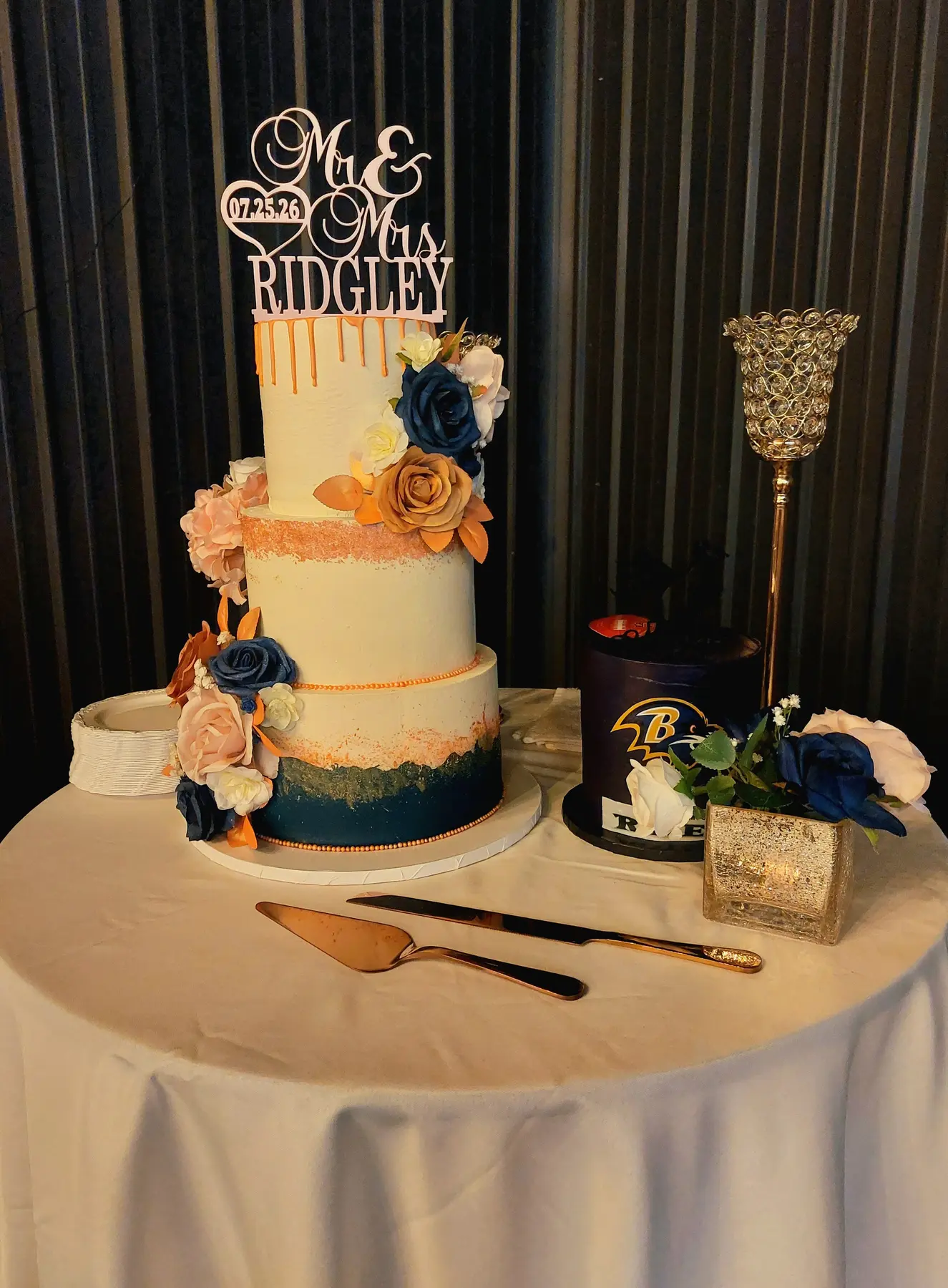 A three-tier wedding cake displayed inside The Dallas Markets event venue
